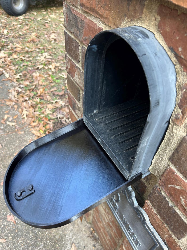Black mailbox with door open showing interior
