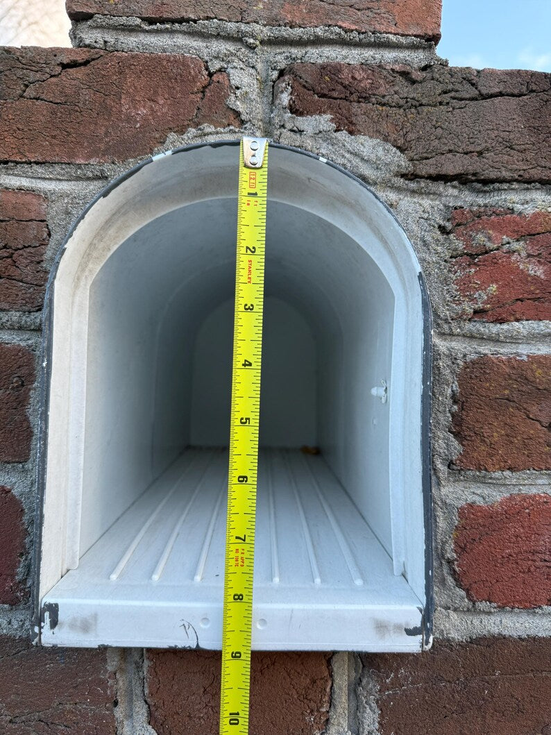 White arched mailbox in brick wall approximately 9 inches deep