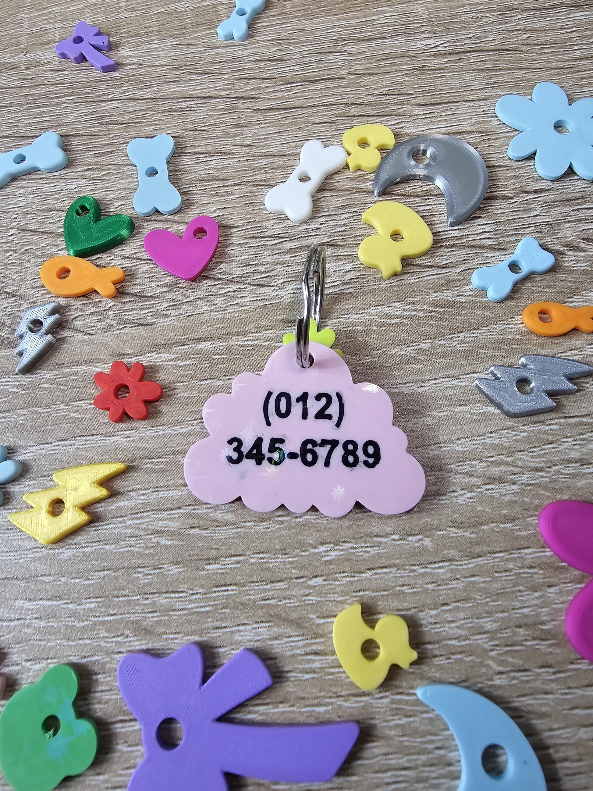 Two-sided cloud tag showing a phone number on the back