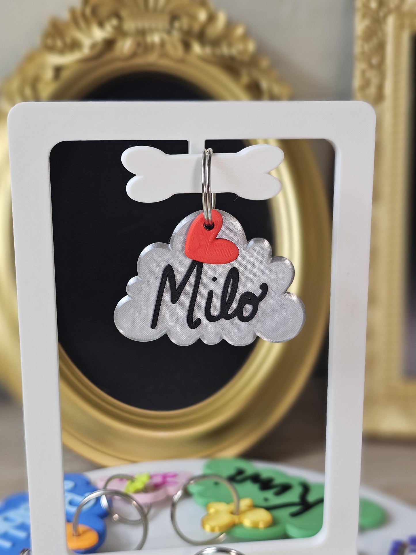 Gray cloud tag with the name Milo and a heart charm