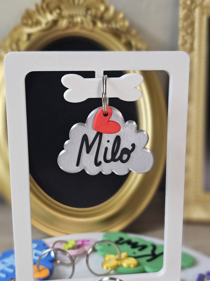 Gray cloud tag with the name Milo and a heart charm