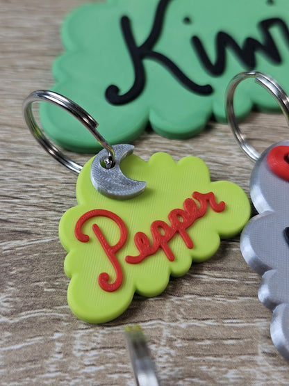Green cloud tag with the name Pepper and a moon charm