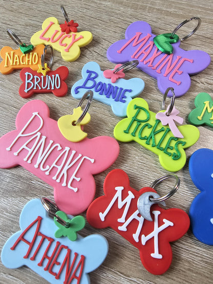 Bone tags with names Lucy, Maxine, and Pickles