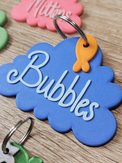Blue cloud tag with the name Bubbles and a fish charm