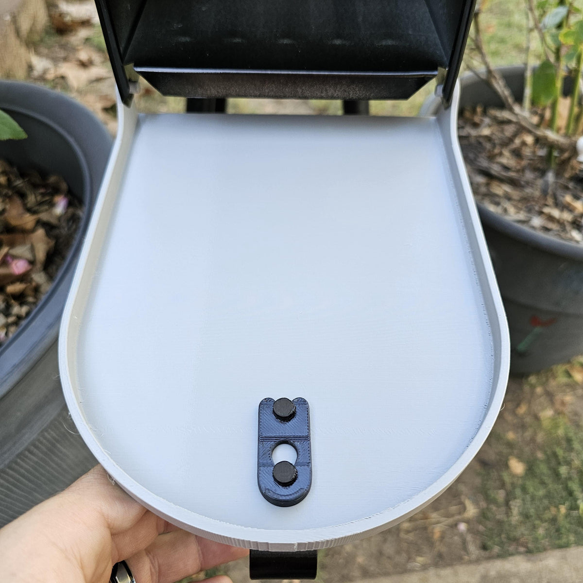 White replacement door open on a metal mailbox, inside face with latch