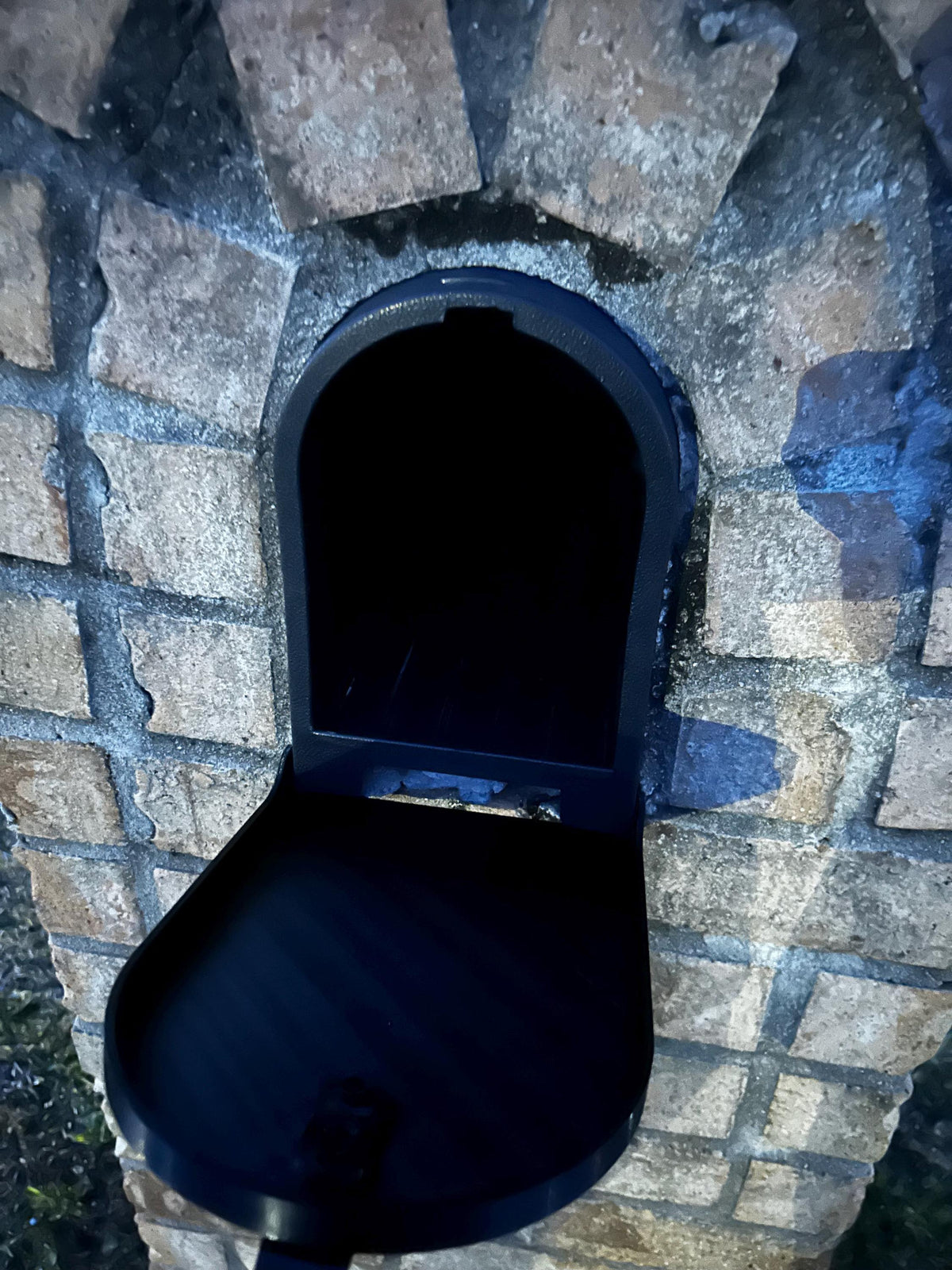 Design 7 mailbox in a stone brick surround with the door open