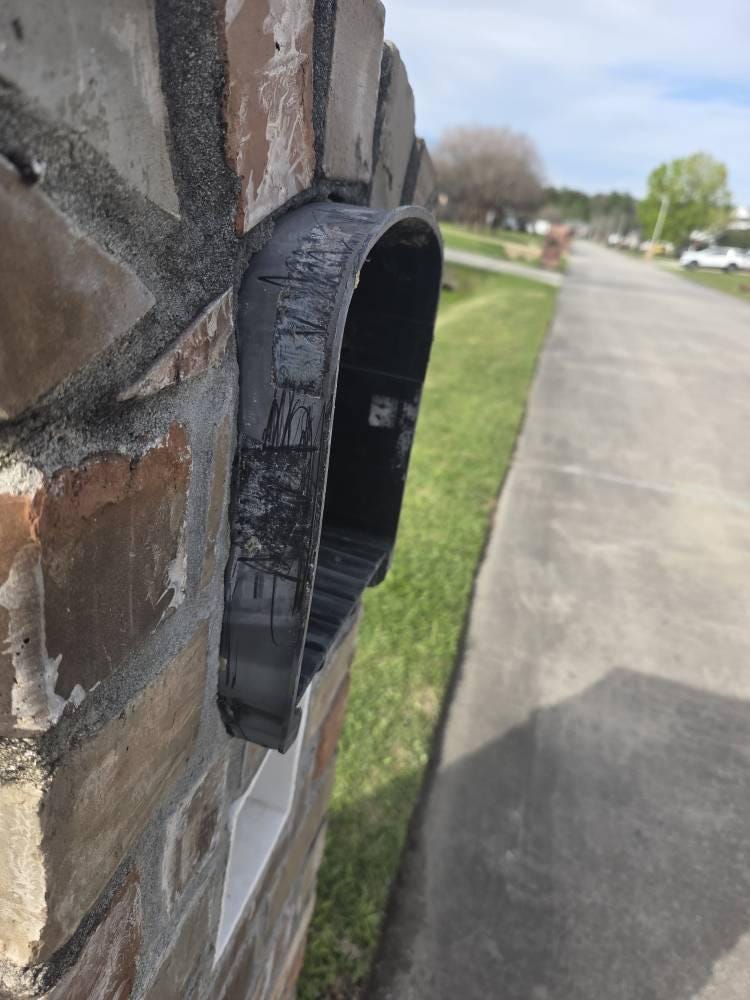 Side view of the Design 9 mailbox in a brick pillar