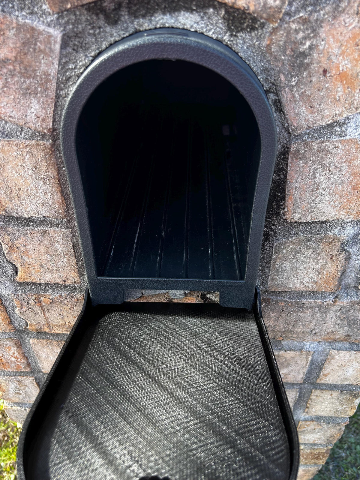 Design 7 mailbox in a brick surround with the replacement door open