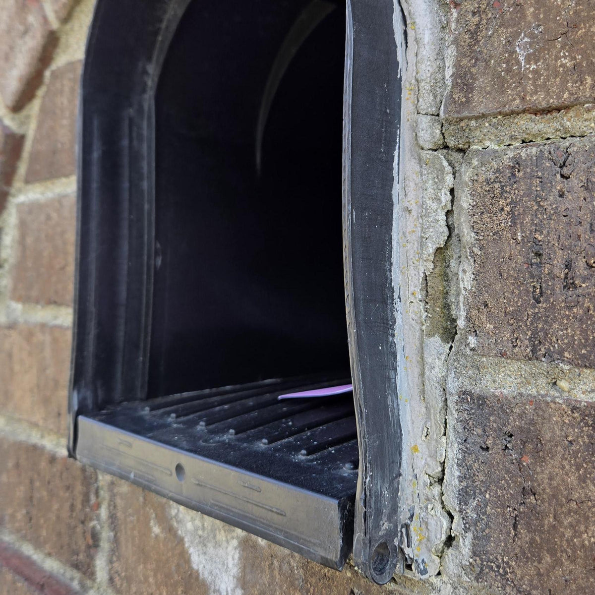Design 1 plastic mailbox insert in a brick opening