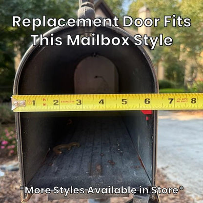 Small metal mailbox this replacement door fits, with a tape measure across the opening