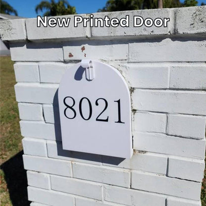 New 3D printed white replacement door with house number 8021 on a white brick mailbox