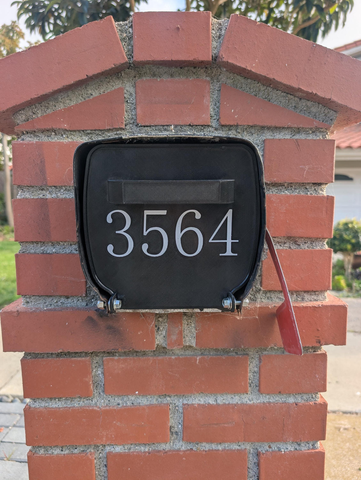 Square metal mailbox replacement door installed, front view
