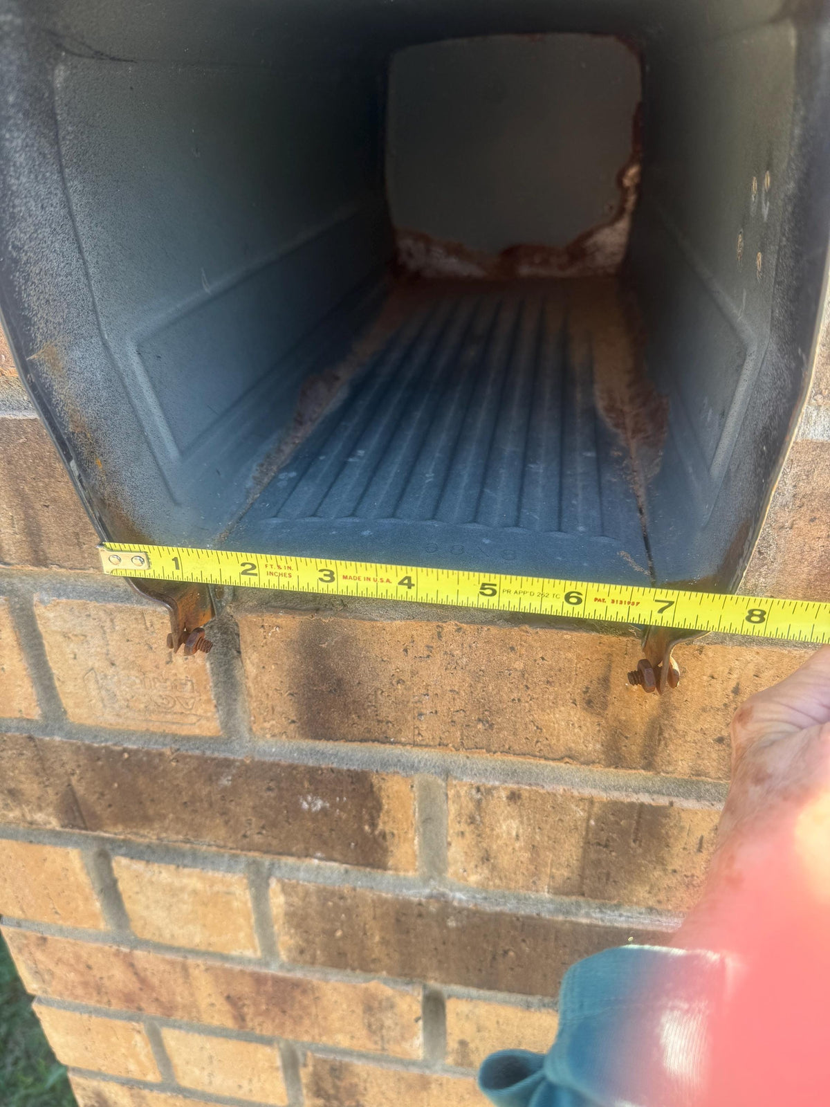 Square metal mailbox opening measured about 8 inches wide at the bottom
