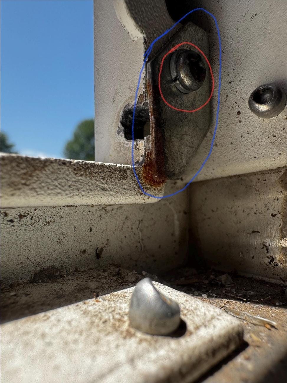 Close-up of the hinge area on the square mailbox frame