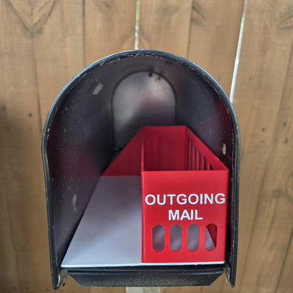 Red outgoing mail bin with white incoming mail tray inside a mailbox