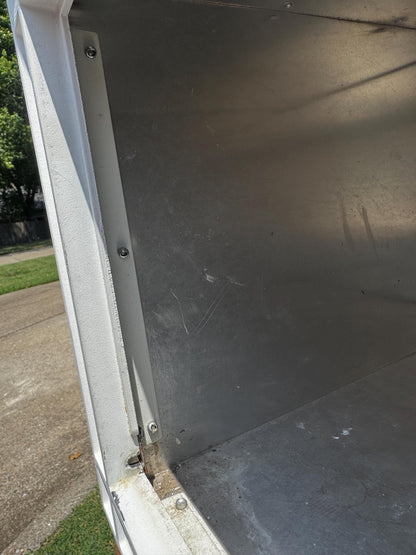 Inside of the square mailbox with the door removed